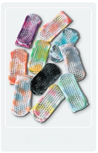 Detailed view of tie-dye yoga socks with non-slip silicone grips on the bottom soles