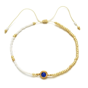 Adjustable stainless steel bead bracelet with a central blue zircon gemstone in gold finish