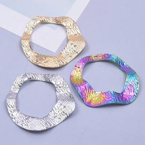 Irregular round hammered stainless steel pendants in gold silver and rainbow finishes