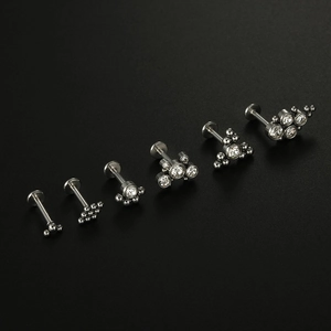 Detailed set of six silver piercing studs with clear cubic zirconia in macro view