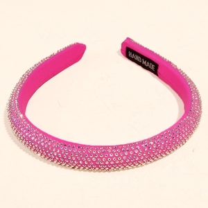 Detailed view of handmade rose pink velvet headband with sparkling white rhinestones