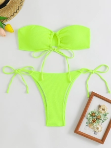 Detail of neon green ribbed fabric on a bandeau bikini set with side-tie bottoms