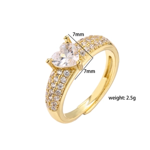 Macro detail of brass heart ring with 7mm cubic zirconia and adjustable band design