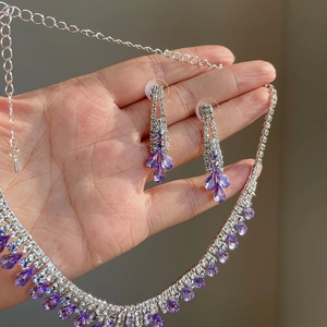 Sparkling purple teardrop rhinestone necklace and earring set with silver finish