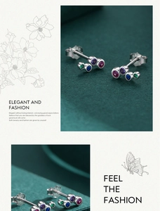 Close-up of S925 sterling silver studs with colorful round gemstones on velvet