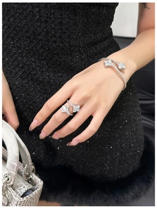 Detail of 18k gold plated open butterfly ring and bracelet with zircon and mother of pearl