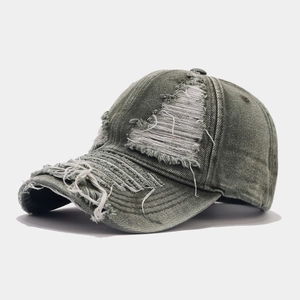Detail of frayed edges and distressed wash on a retro street style baseball cap