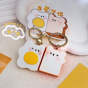 Cute acrylic breakfast keychain set featuring fried egg and toast on golden metal rings