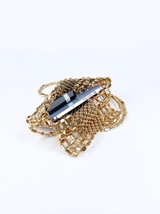 Detail shot of the golden beaded mesh crossbody bag with metallic woven chain and phone pocket