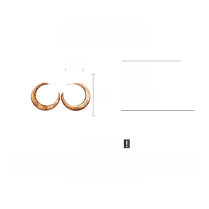 Detailed view of amber resin C-shaped hoop earrings with 5cm x 4.5cm dimensions
