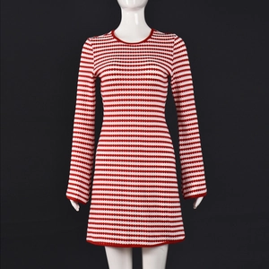Détail de la texture en maille à rayures rouges et blanches d'une mini robe manches longues