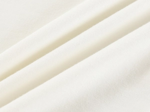 Macro shot of white soft knitted cotton fabric texture with fine breathable fibers