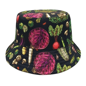 Detailed close-up of a black bucket hat with colorful vegetable patterns and cotton texture