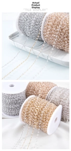 Detail of copper gold and silver chains with clear crystal beads on a marble tray