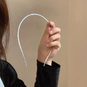 Elegant thin silver metal headband with sparkling zircon stones held in hand