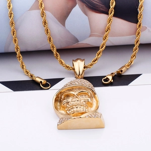 Detailed close-up of golden hooded skull pendant with sparkling diamonds and twist chain