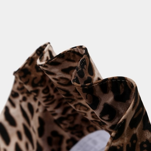 Macro shot of leopard print sun hat fabric with detailed stitching and wavy edges