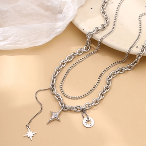 Detail of silver double-layered chain necklace with North Star pendant and zircon inlay