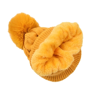 Detailed view of the ginger knit beanie with thick thermal plush fleece lining and fur pompom