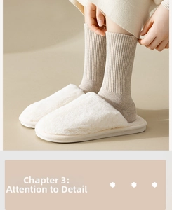 Detail of plush faux fur slippers in ivory white with striped cotton socks for home comfort