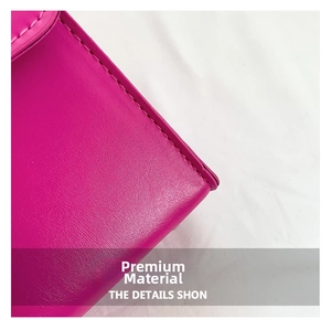 Detailed close-up of premium leather texture and stitching on a fuchsia crossbody bag