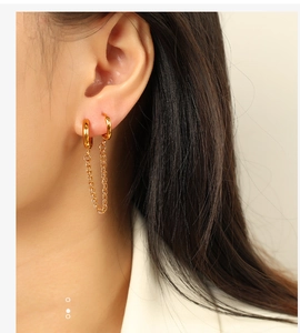Detailed view of gold chain link earrings with double hoop minimalist design