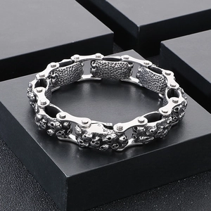 Detail shot of vintage silver skull relief links on a punk style titanium steel bracelet