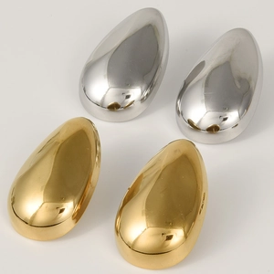 Macro detail of teardrop earrings in polished 18k gold and silver stainless steel finish