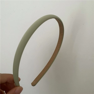 Detail of light green slim headband showing brown anti-slip inner lining texture