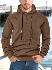 Detailed view of dark brown waffle knit texture on casual men hoodie with black drawstrings
