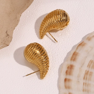 Macro view of gold plated hollow twisted teardrop stud earrings with spiral texture
