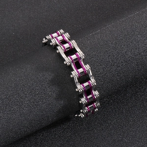 Detail of silver stainless steel motorcycle chain bracelet with purple segments on black background