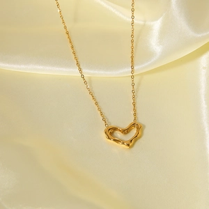 Irregular liquid heart necklace in 18k gold plated stainless steel on silk background