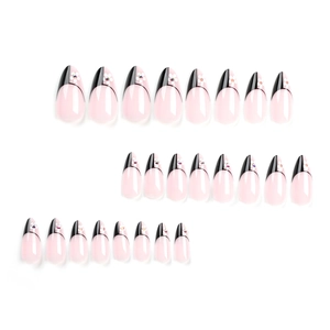 French almond fake nails with black geometric tips, white flowers, and crystals