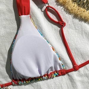 Close-up of red floral bikini top with mesh lining and metal ring connectors