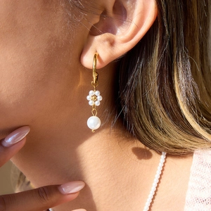 Eleganti orecchini a perla con fiori in oro 18K a cerchio C indossati da modella