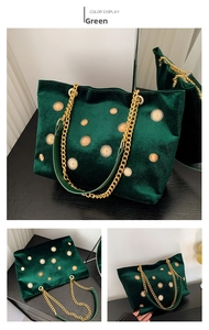 Detail of emerald velvet tote bag with gold sun studs and metallic chain strap