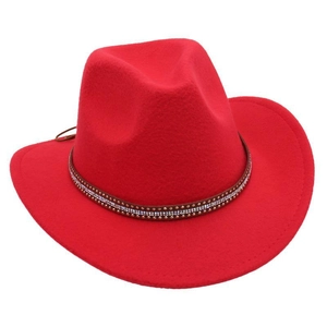Macro detail of red felt cowboy hat featuring brown band with metallic stud rivets