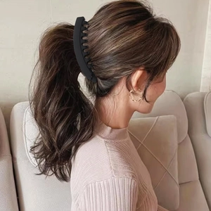 Detail of 13cm matte black banana hair clip worn on a ponytail for secure grip