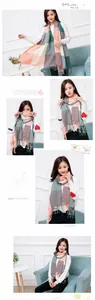 Detail of plaid imitation cashmere scarf with tassels and heart embroidered sweater