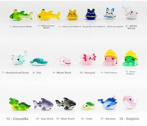 Flat lay of 18 colorful resin ocean animal figurines including sharks and sea turtles