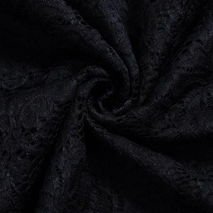 Detailed close-up of intricate black floral lace fabric with delicate hollow-out patterns