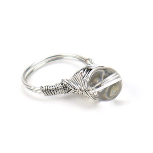 Detail of silver wire-wrapped ring with a translucent grey moonstone crystal bead