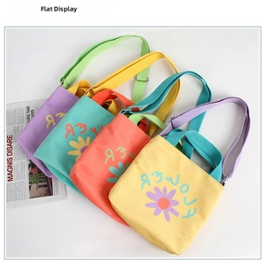 Detail view of canvas tote bags in four candy colors with cute floral daisy prints