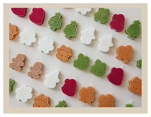 Detailed grid of Christmas candles including Santa, tree, snowman and gingerbread man shapes