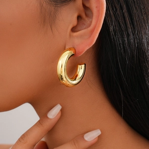 Polished chunky gold-plated C-shape hoop earrings in minimalist geometric metal style