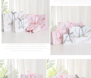 Detail of pink and white marble pattern gift bags with Sweet Times gold foil text