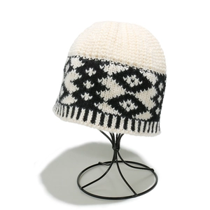 Detailed close-up of bohemian geometric diamond knit pattern on winter beanie
