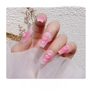 Detail of 3D transparent resin heart charms on pink blush gradient nail art design