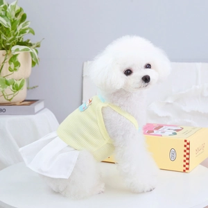 Detail of light yellow knitted dog dress with a cute fabric patch on the back